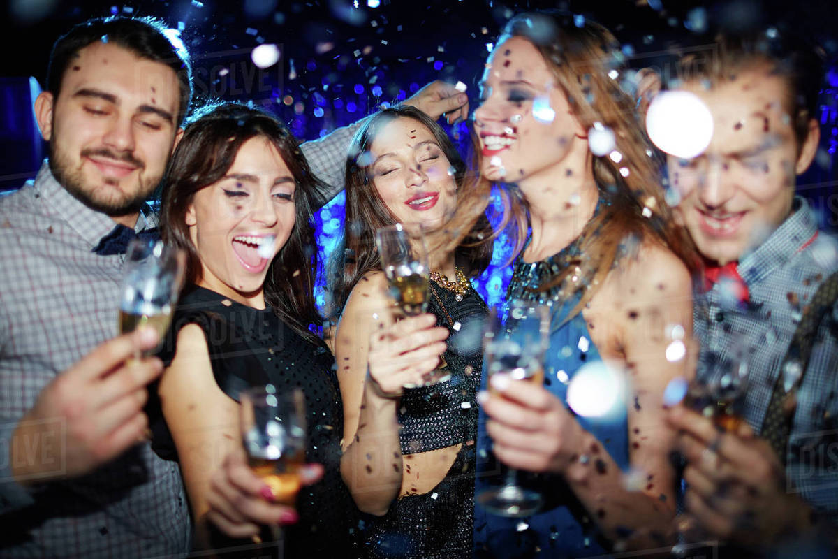 Group of friends toasting with champagne at party in night club - Stock - Party City Teenage Mutant Ninja Turtles Costume