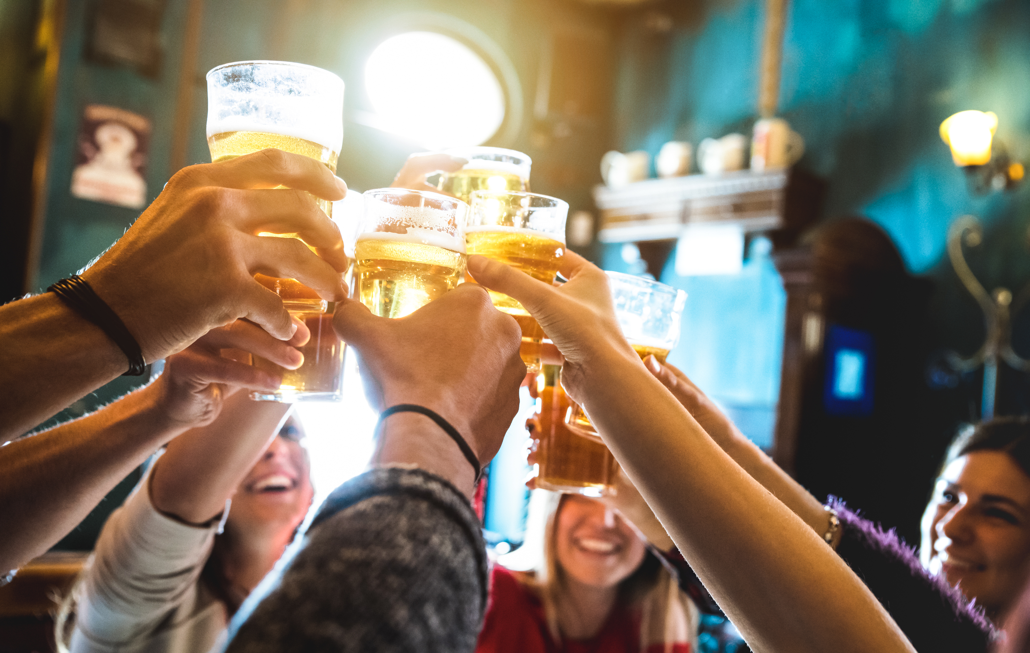Group of happy friends drinking and toasting beer at brewery bar - Does Drinking Water Help Erectile Dysfunction