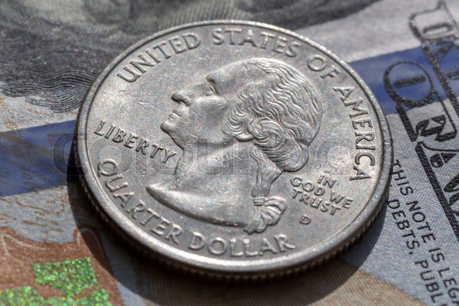 quarter dollar coin lying on one hundred dollars banknote | Stock image - How Many Quarter In 10 Dollars