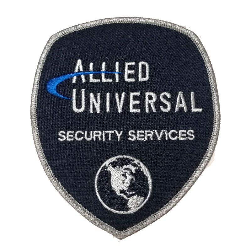 the logo on a patch that says,'allied universal security services'in - Allied Universal Security Services San Jose Photos