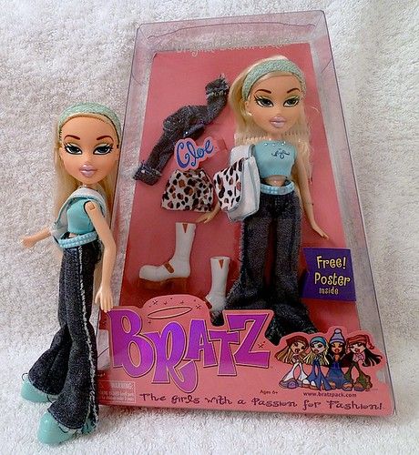 two dolls are sitting in a box on the floor next to each other and one - Karol G Bratz Doll Release Date
