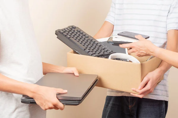 Volunteer collecting used technology gadgets to charity. Donation box - Benefits Of Donating Computer Equipment Include